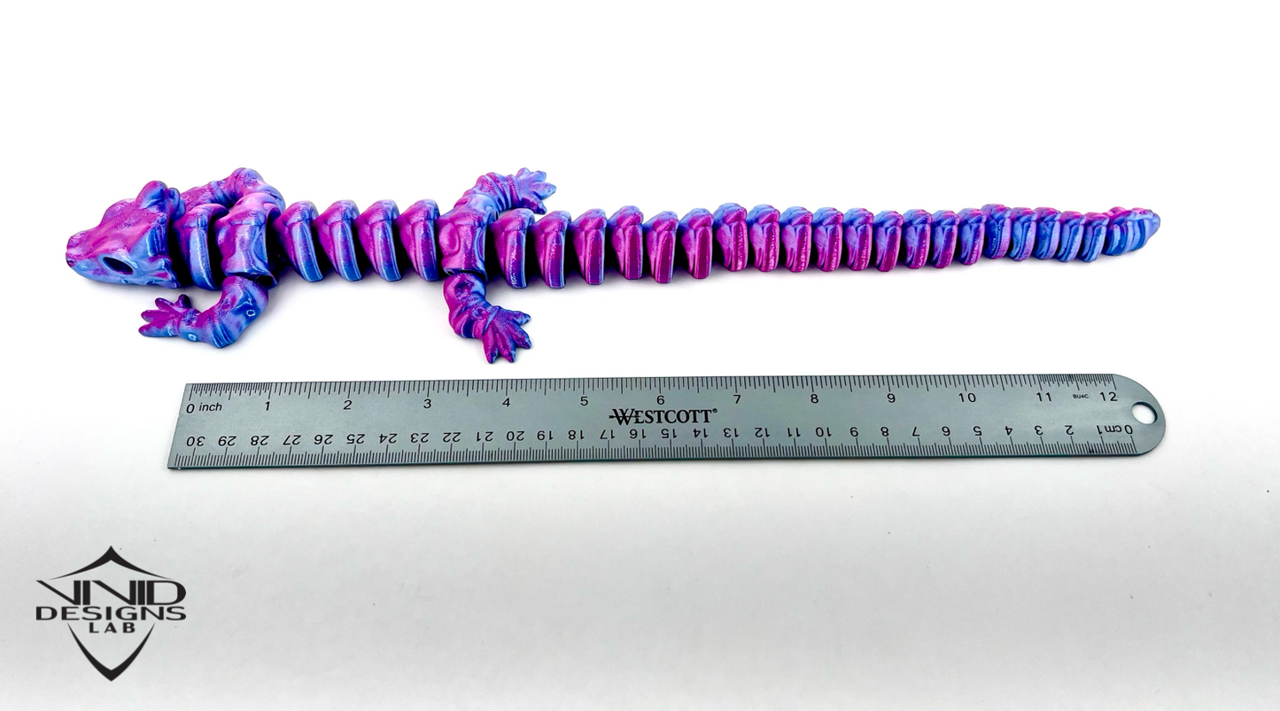 Purple and blue ribbed object next to a ruler on a white background