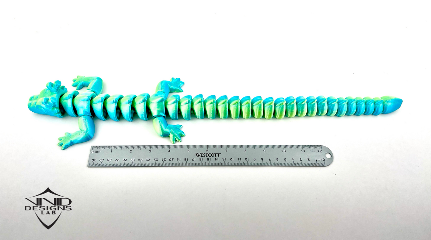 bright and colorful 3D printed dragon next to ruler with which background, toy