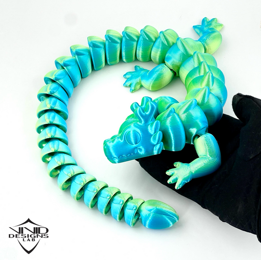 holding 3D printed articulated dragon, bright blue and green color, high quality toy